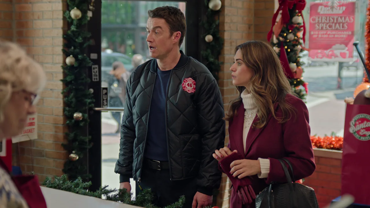 Two leads in a hardware store beside the shop window, with a summer street outside, as filmed